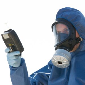 a person in a hazard suit testing the air